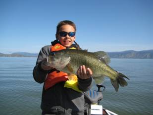 Boy holding bass fish